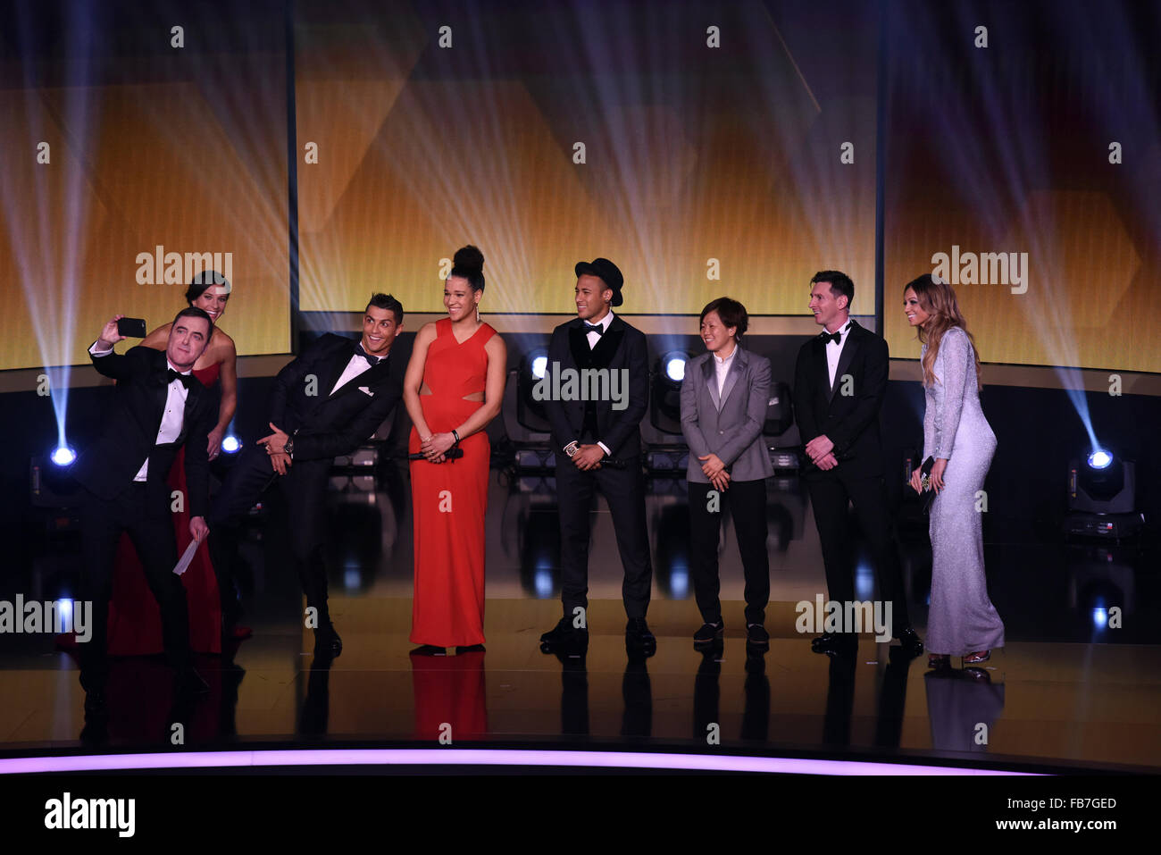 Zurich, Switzerland. 11th Jan, 2016. Presenter of the show James Nesbitt (L) takes a selfie with (L-R) Carli Lloyd of the USA and Houston Dash, Cristiano Ronaldo of Portugal and Real Madrid, Celia Sasic of Germany, Brazil's Neymar, Aya Miyama of Japan, Barcelona's Lionel Messi of Argentina and presenter Kate Abdo during the FIFA Ballon d'Or Gala 2015 held at the Kongresshaus in Zurich, Switzerland, 11 January 2016. Photo: Patrick Seeger/dpa/Alamy Live News Stock Photo