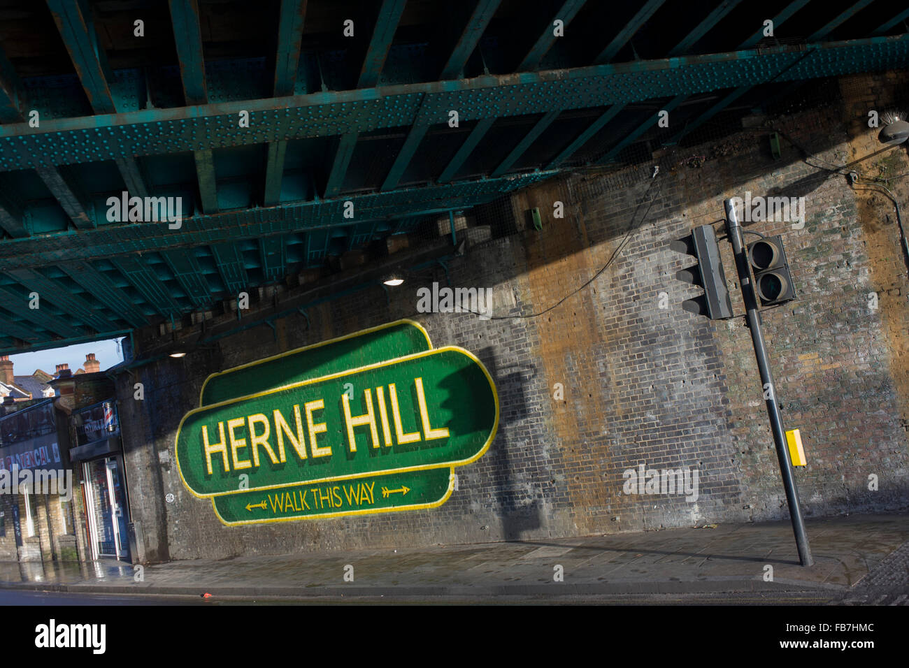 Old railway-style sign under railway bridge in Herne Hill, South London SE24. Stock Photo