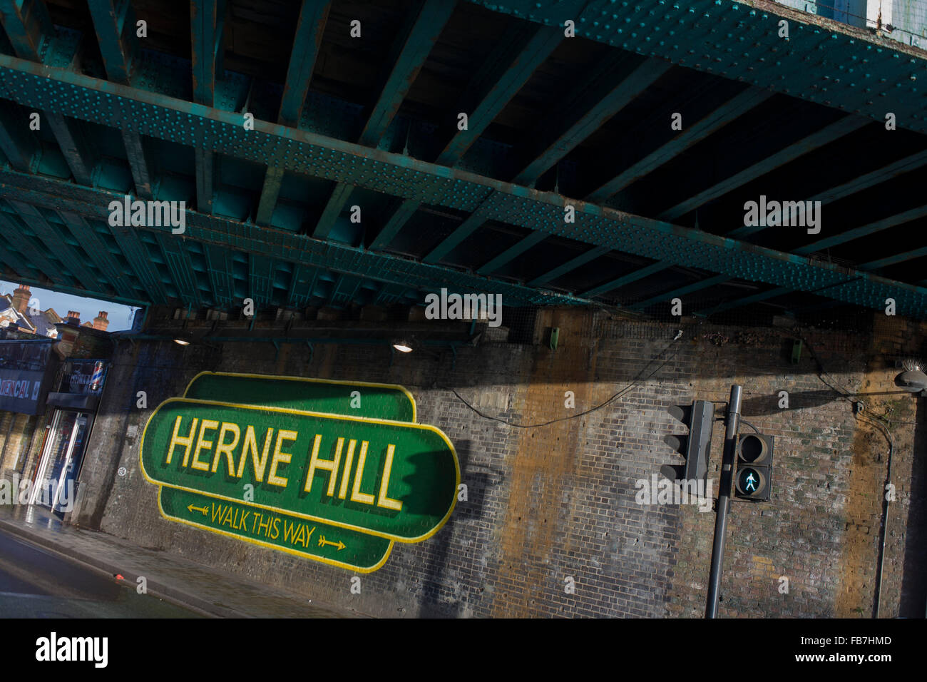 Old railway-style sign under railway bridge in Herne Hill, South London SE24. Stock Photo