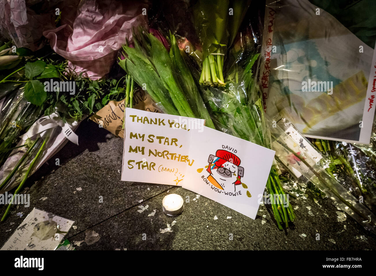 London, UK. 11th January, 2016. Fans gather at the David Bowie mural in Brixton, south London for an evening remembrance vigil, to lay flowers and leave messages. David Bowie (1947-2016) who passed away on 10 January 2016 Credit:  Guy Corbishley/Alamy Live News Stock Photo