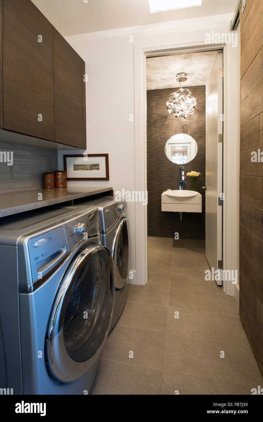 Laundry room interior. Utility room with washing machine, cleaning  equipment, home cleaners, clean wipes, hanging colorful shirts on  clothesline on wh Stock Photo - Alamy
