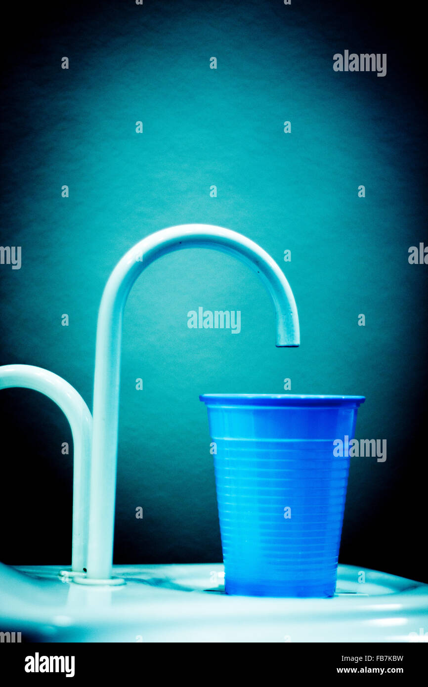 Dentists dental rinse tap and cup in clinic photo. Stock Photo