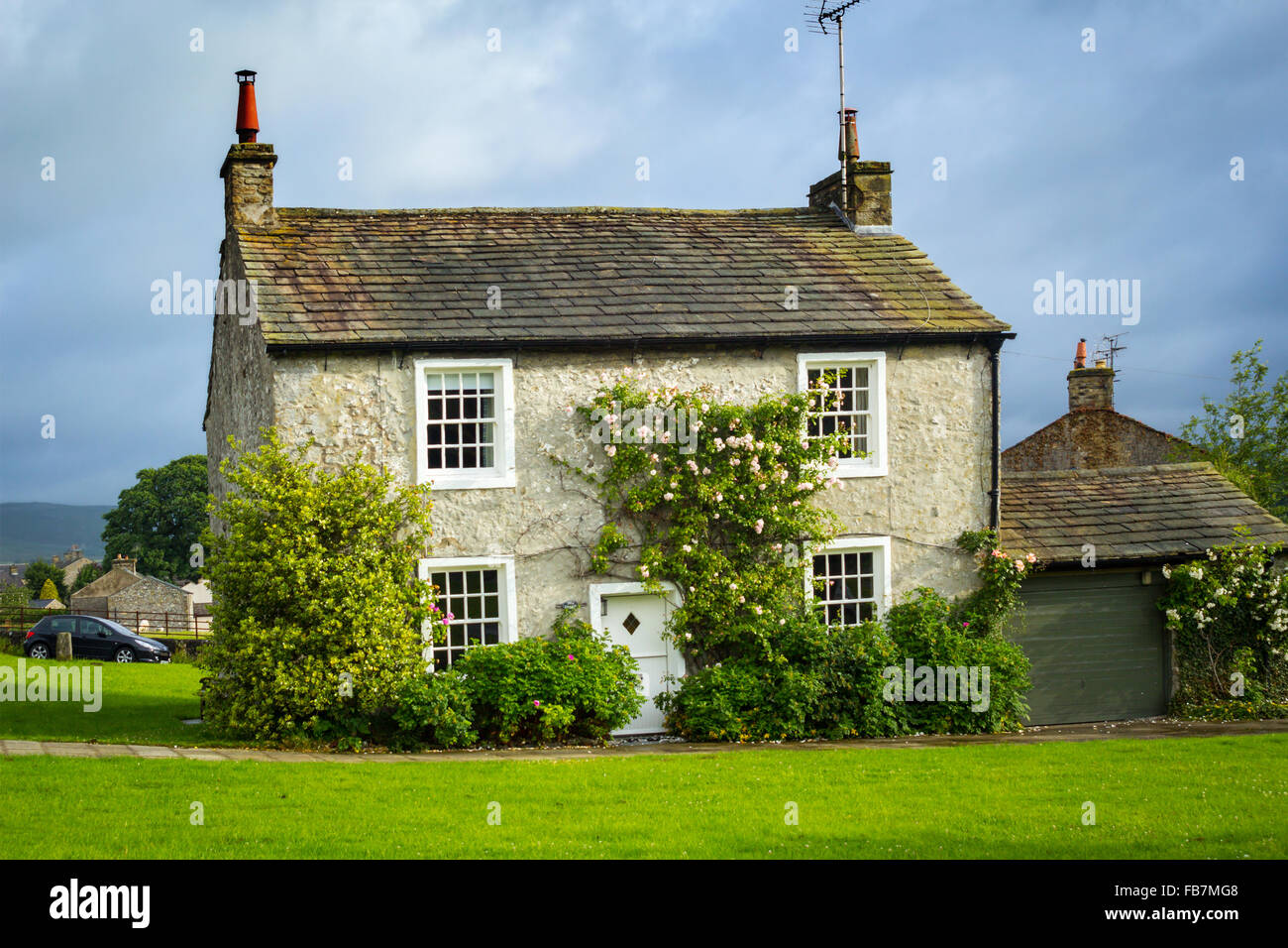 Beautiful English village house with climbing roses, Yorkshire, England Stock Photo