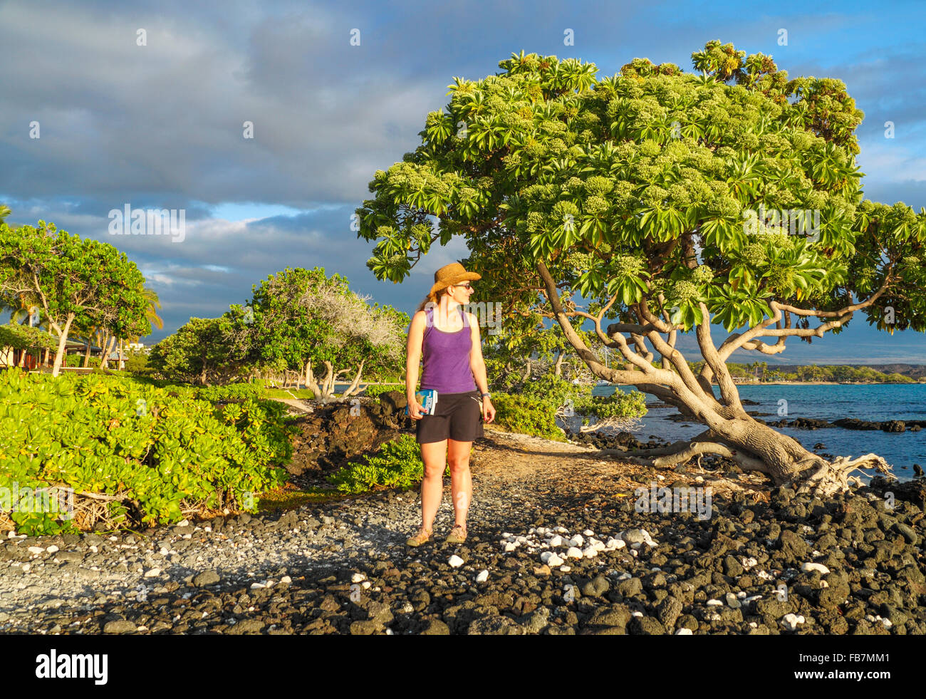 Woman on the King's Highway, a coastal path in Waikoloa Stock Photo
