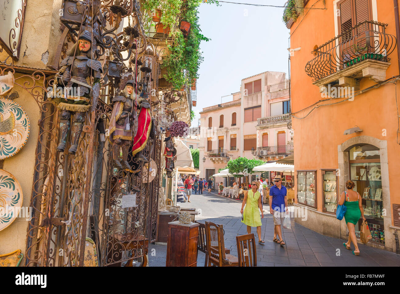 Taormina shopping Sicily, view of a middle-aged tourist couple looking at an elaborate display outside an antiques shop in the Corso Umberto I. Stock Photo