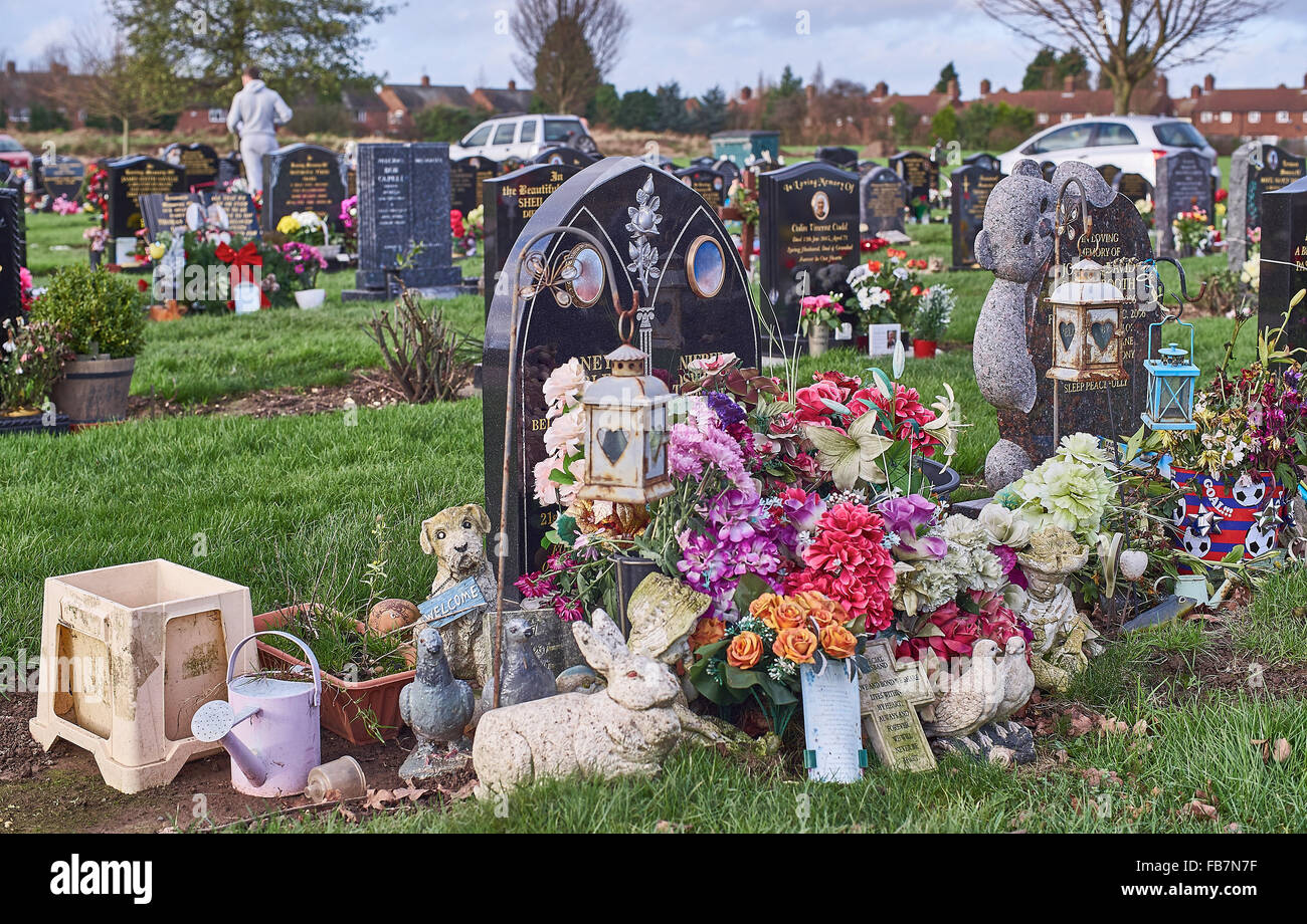 Gravestones at a cemetery in Hull decorated with memorial ornaments
