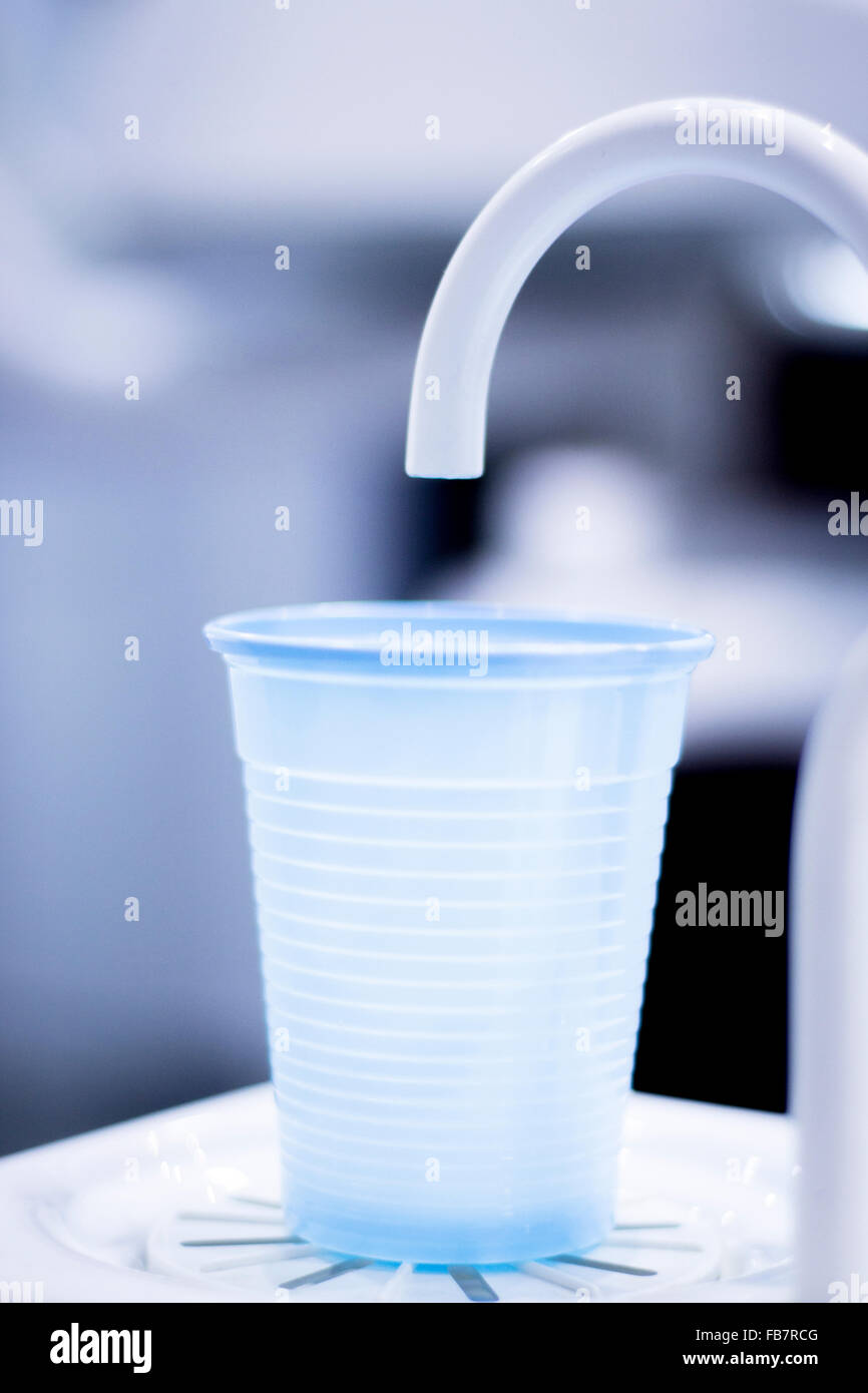 Dentists dental rinse tap and cup in clinic photo. Stock Photo