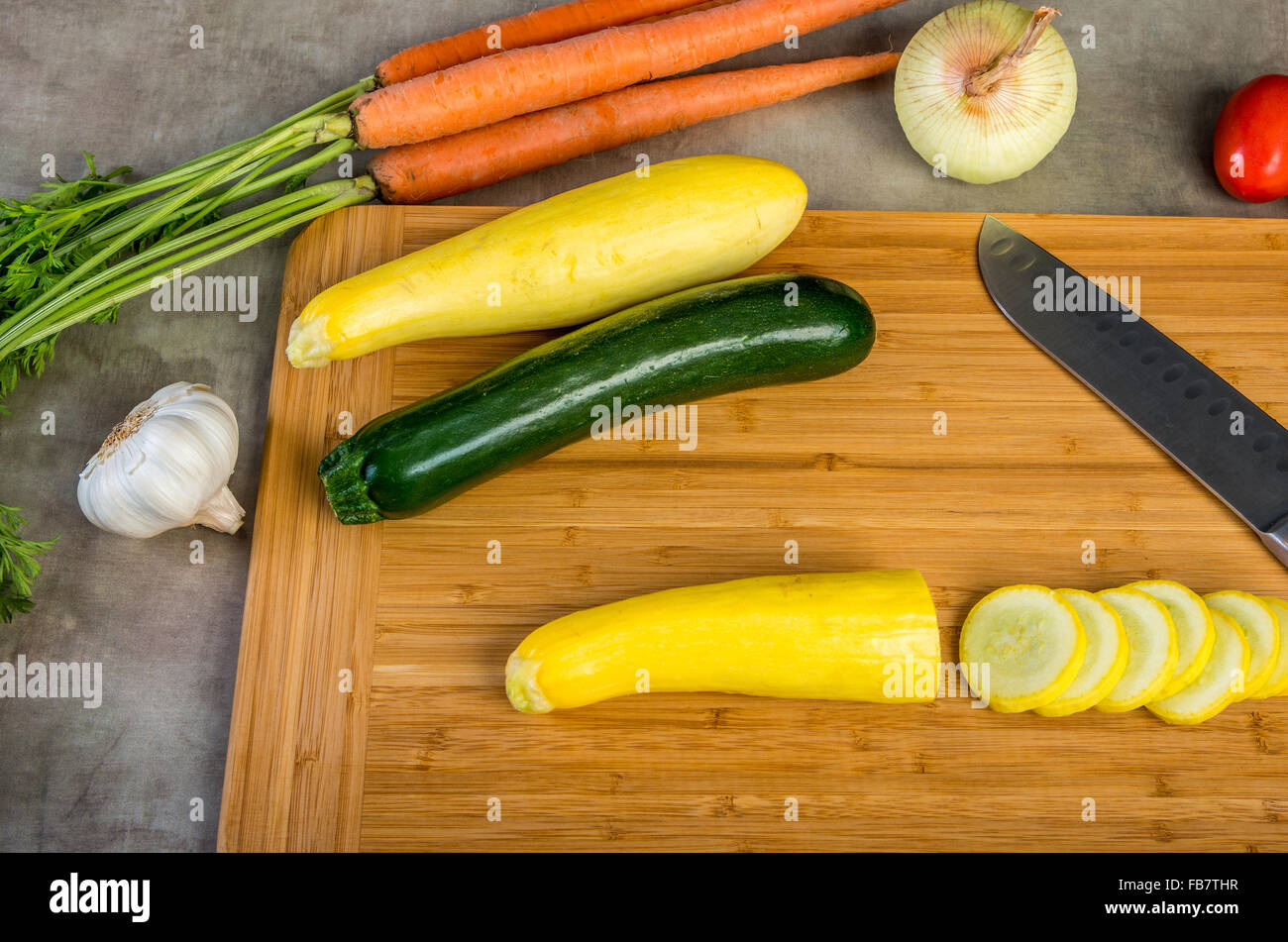 Wooden cutting board with vegetables Stock Photo