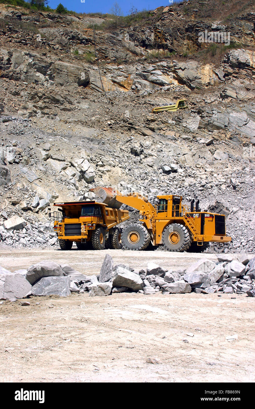 Stone after it is blasted loose from a rock quarry and is loaded for