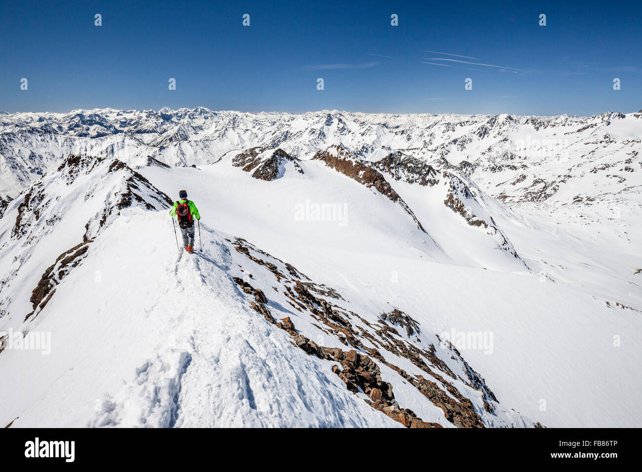 Ski tourer, descending from the Finail summit on the ridge, Val Senales, Meraner Land, Alps, South Tyrol Province Stock Photo