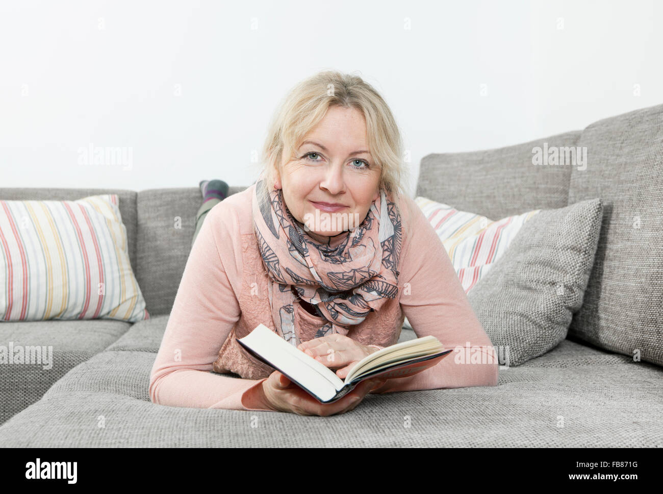 Older woman relaxing sofa hi-res stock photography and images - Alamy