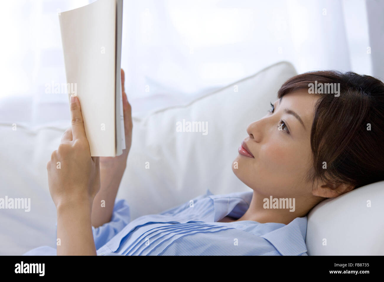Young woman reading a book Stock Photo - Alamy