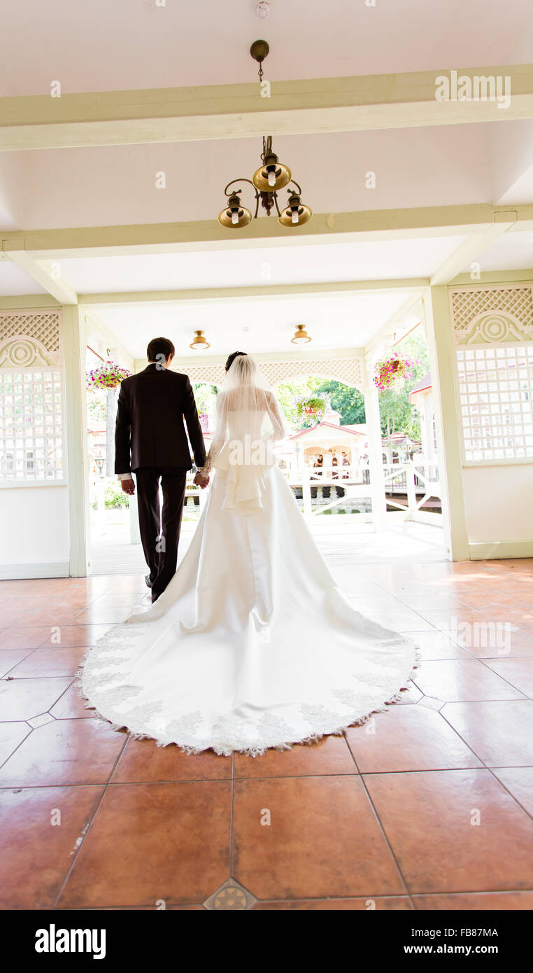 Back view of holding hands bride and groom Stock Photo - Alamy