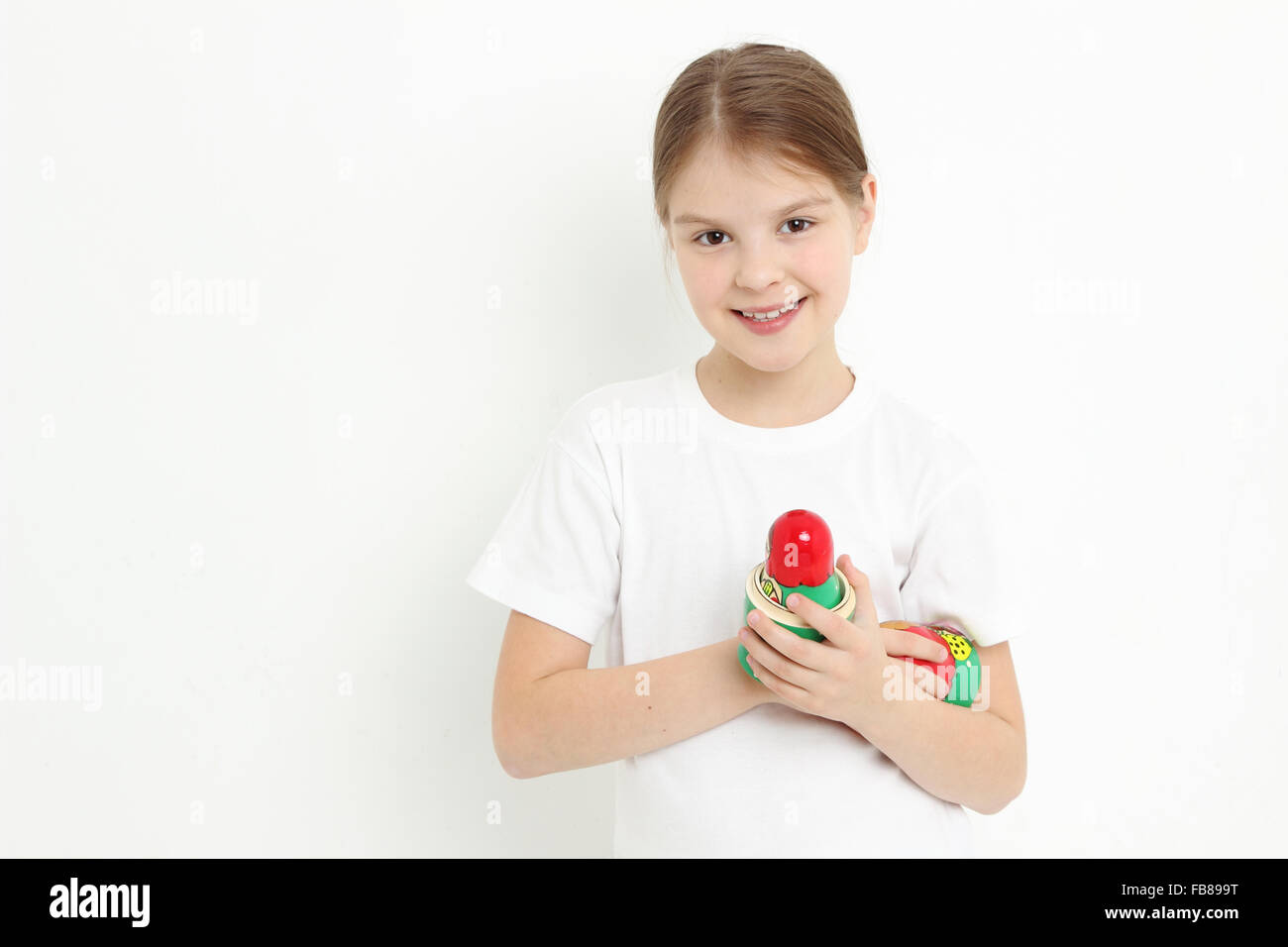 Cheerful european teen girl holding matryoshka Stock Photo