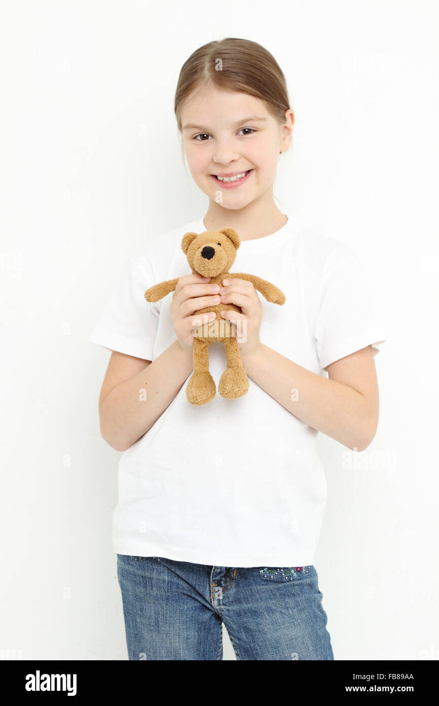 Teen girl holding a toy bear Stock Photo - Alamy