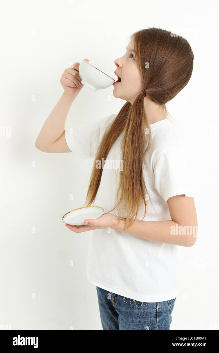 Pretty little girl holding tea cup Stock Photo Alamy