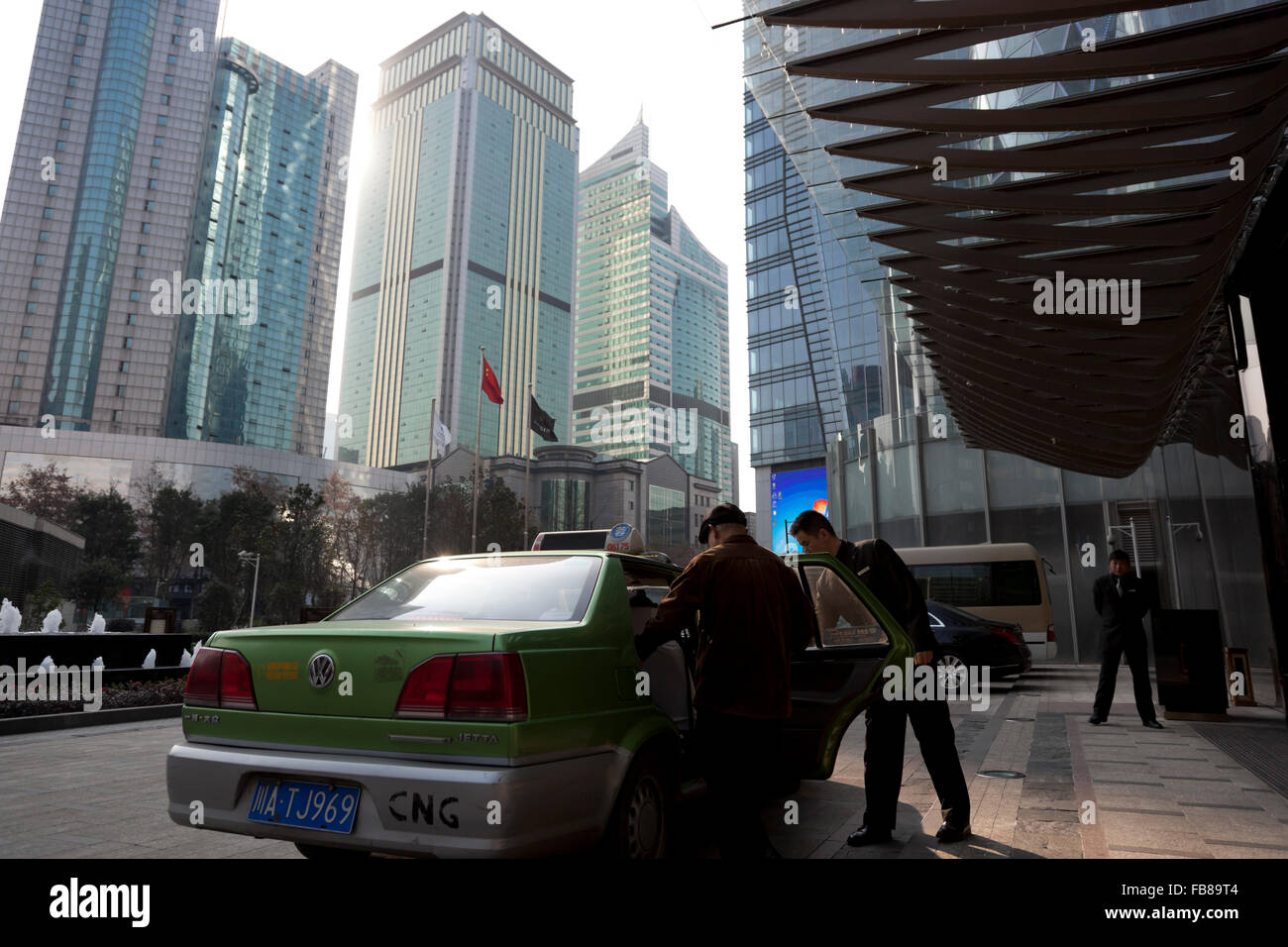 People getting into a taxi outside an upscale hotel at the centre of Chengdu in China. Stock Photo