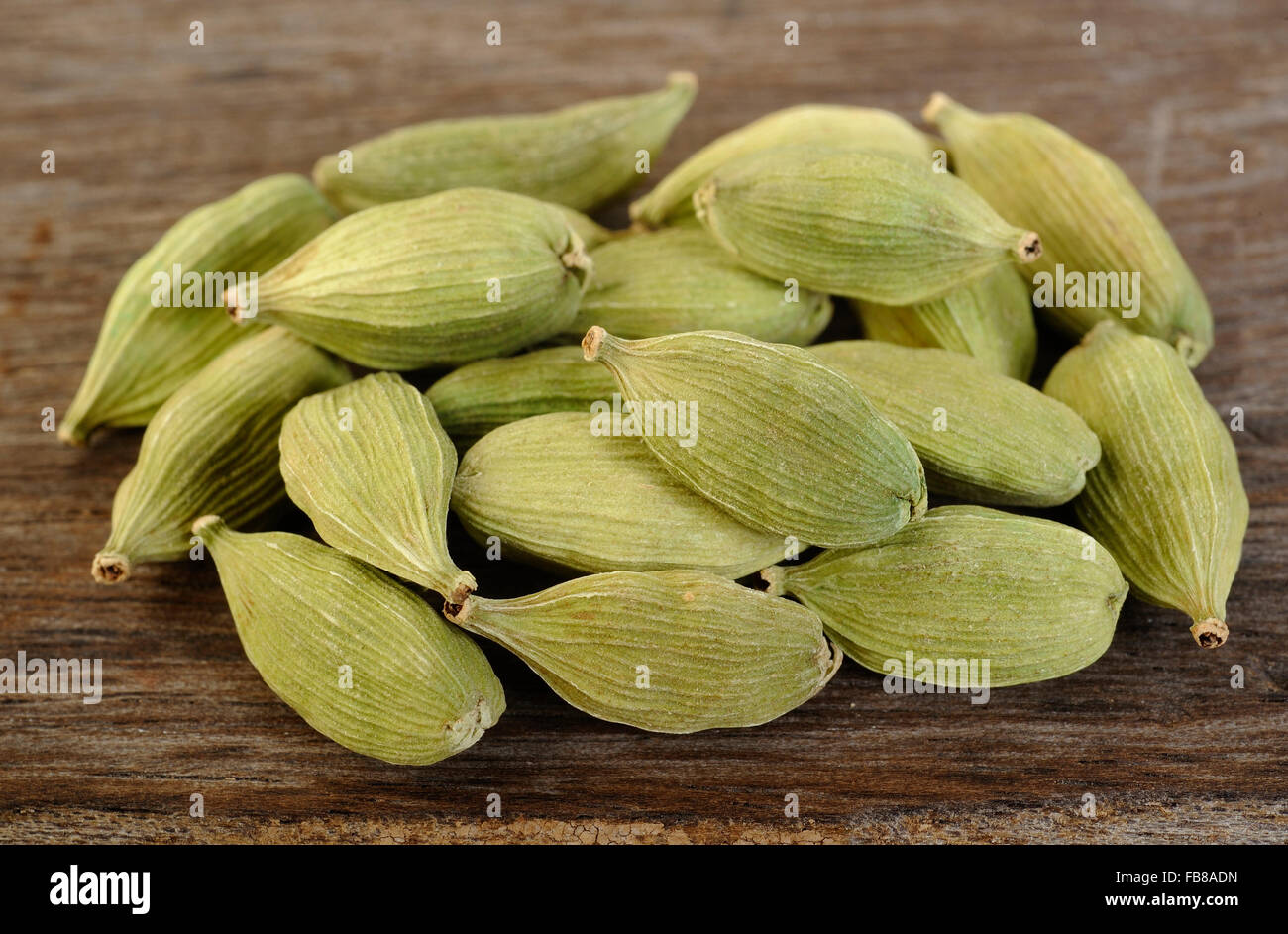 green cardamom pods on wooden background Stock Photo Alamy