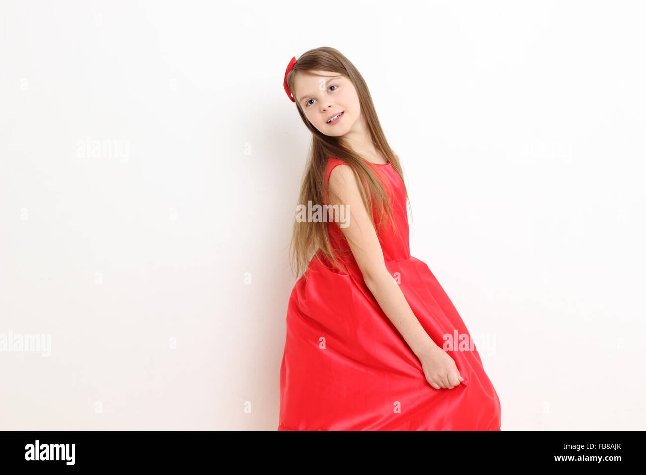Pretty little girl wearing red dress Stock Photo Alamy