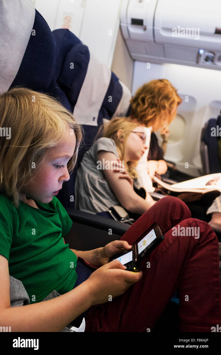 Sweden, Mother travelling by plane with children (6-7, 10-11) Stock Photo