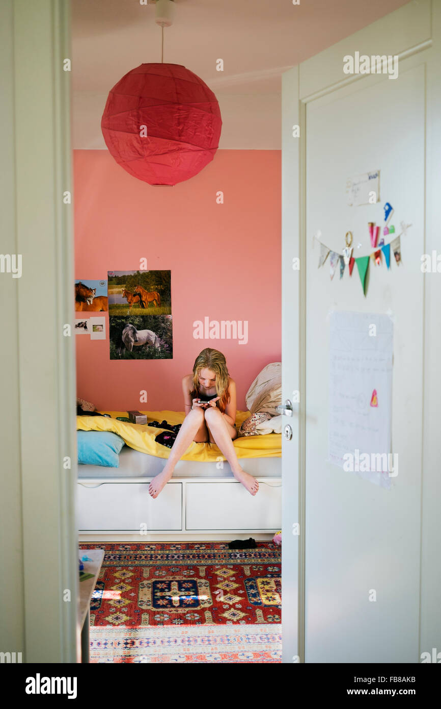 Sweden Girl 12 13 Texting In Her Bedroom Stock Photo