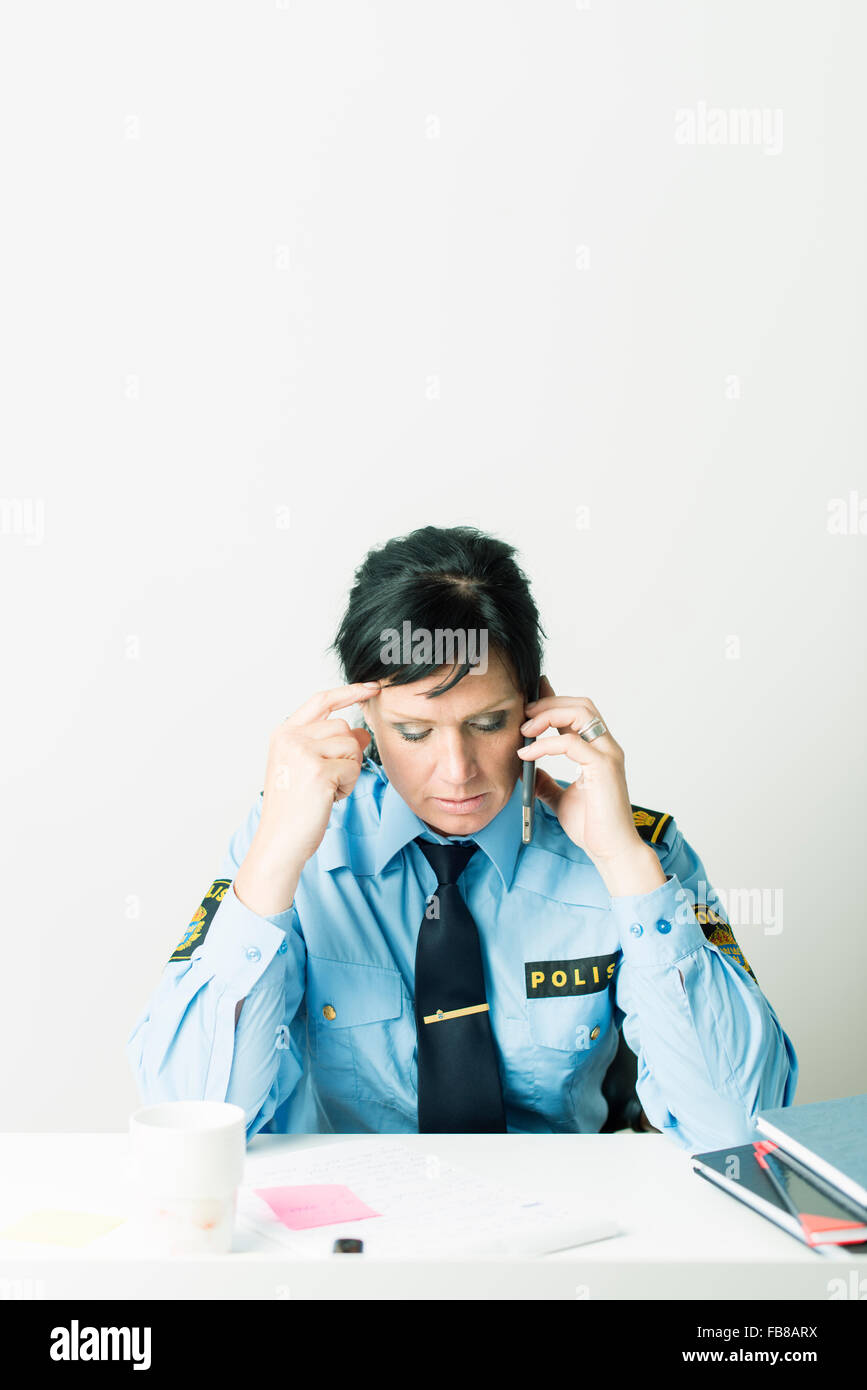 Sweden, Policewoman doing paperwork Stock Photo