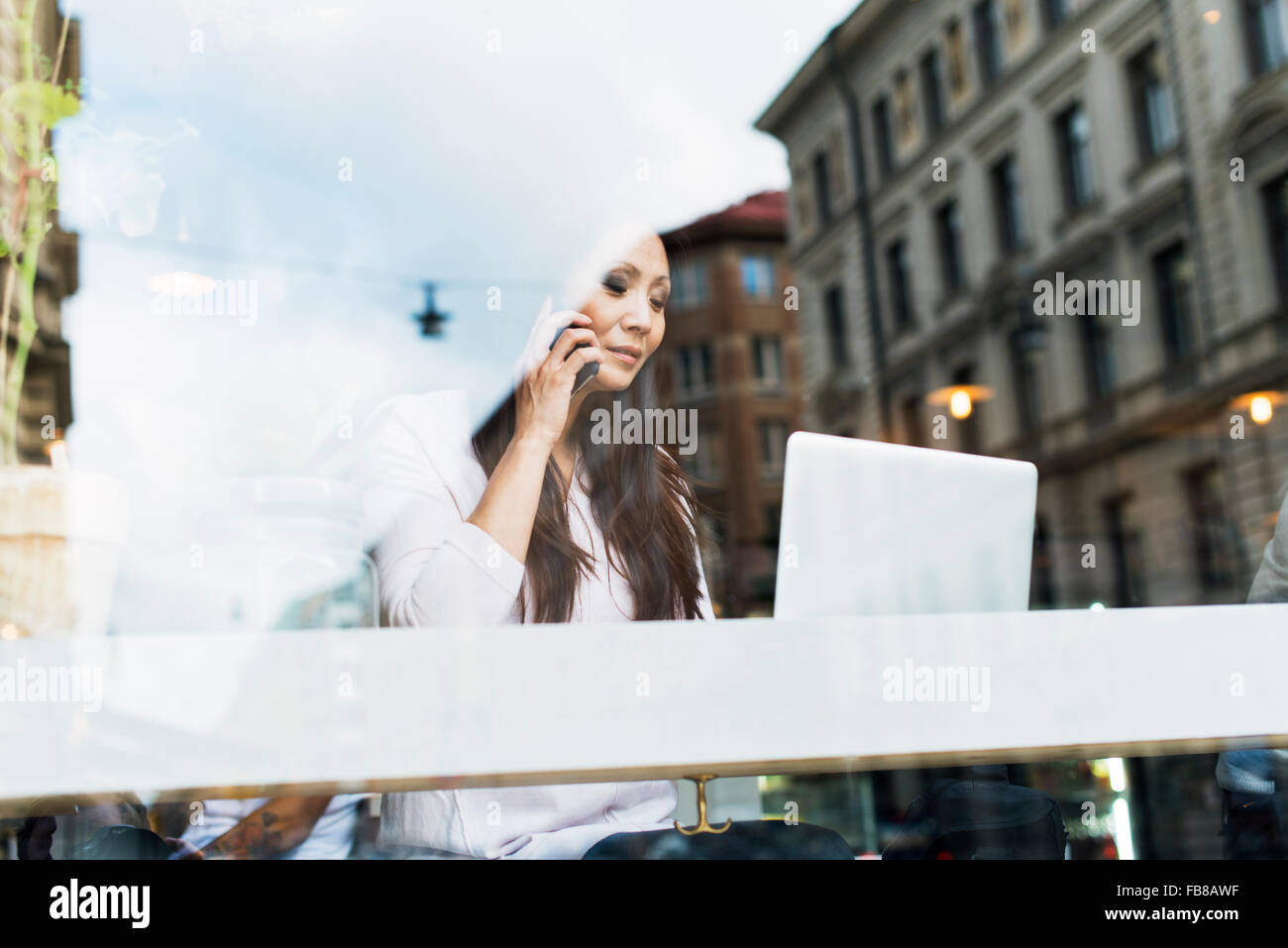 Sweden, Uppland, Stockholm, Woman talking on phone Stock Photo