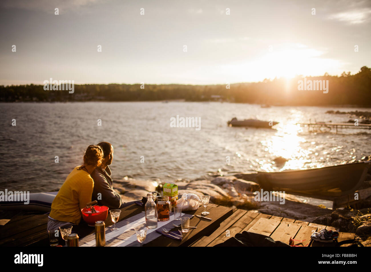 Sweden, Medelpad, Alnon, Couple looking at sunset Stock Photo