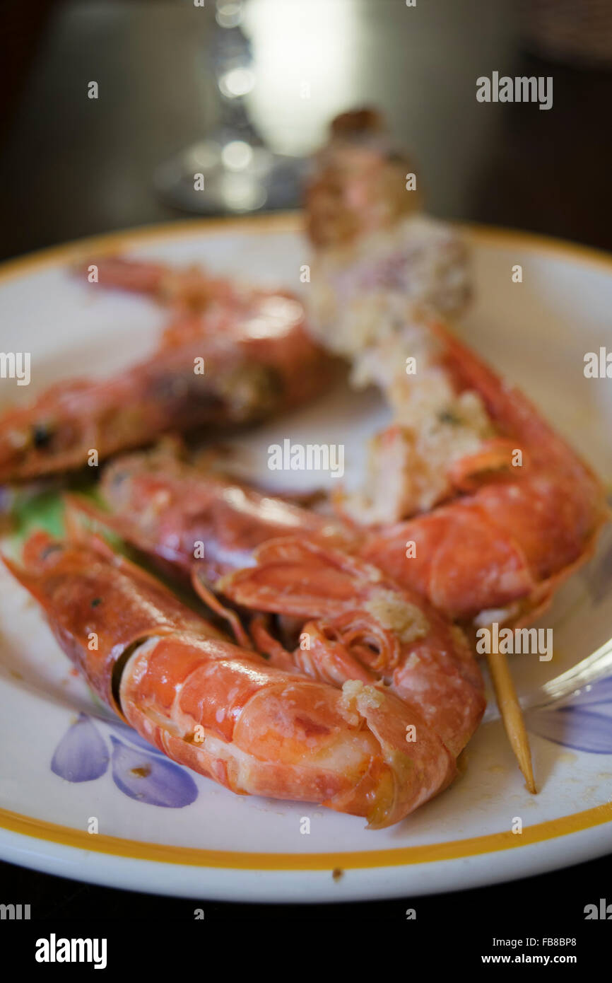breaded and fried skewers of fish with near some jumbo prawns Stock