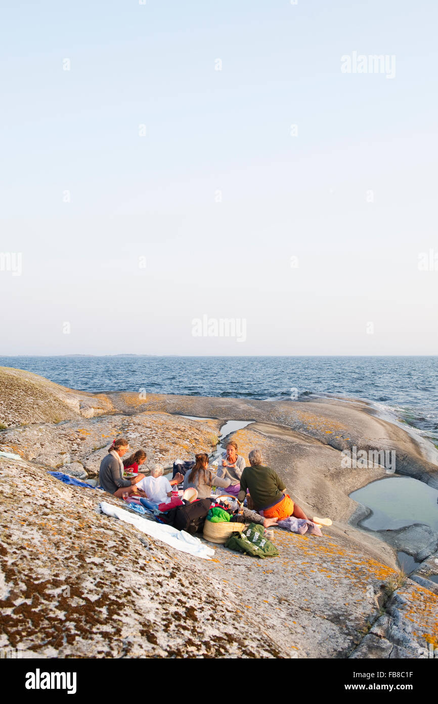 Woman leaning on rocks hi-res stock photography and images - Alamy
