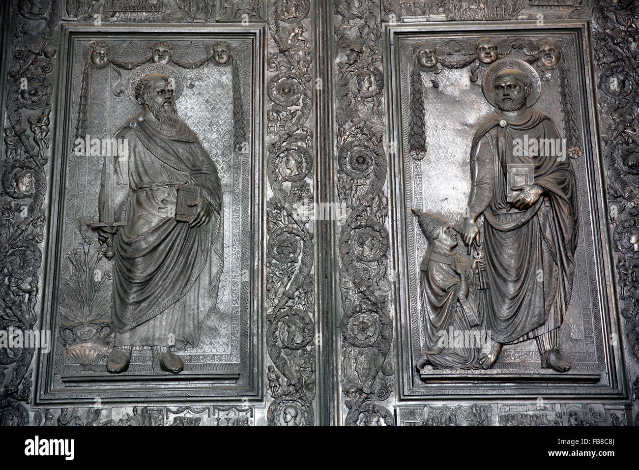 The Filarete Doors at Saint Peter's Cathedral in the Vatican. The bronze doors depict St Paul (left) and St Peter (right). Stock Photo