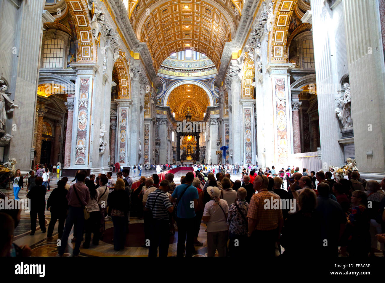 Tourists and pilgrims in Saint Peter's Cathedral in the Vatican Stock Photo