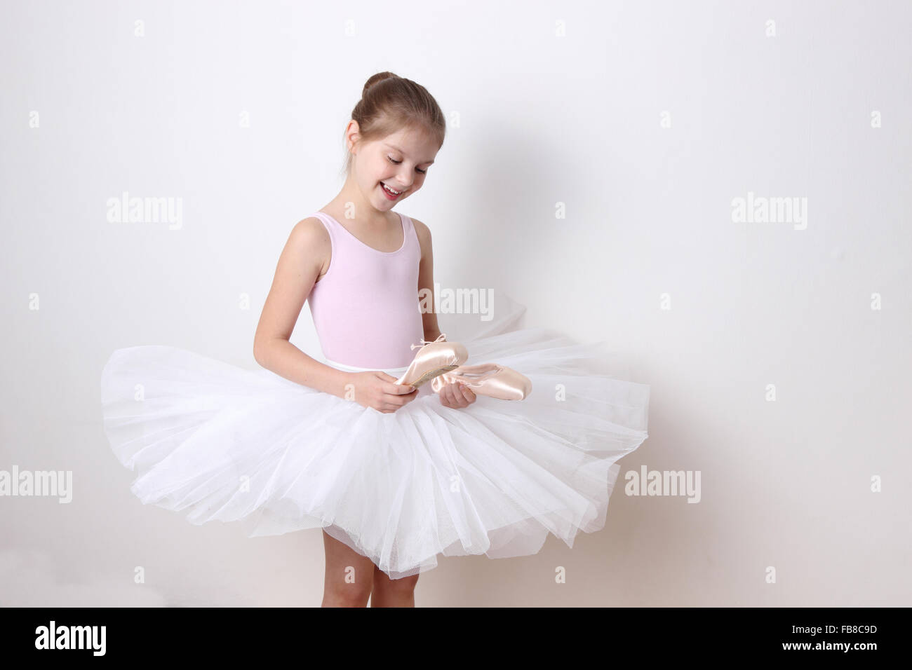 little ballerina in studio posing on camera Stock Photo