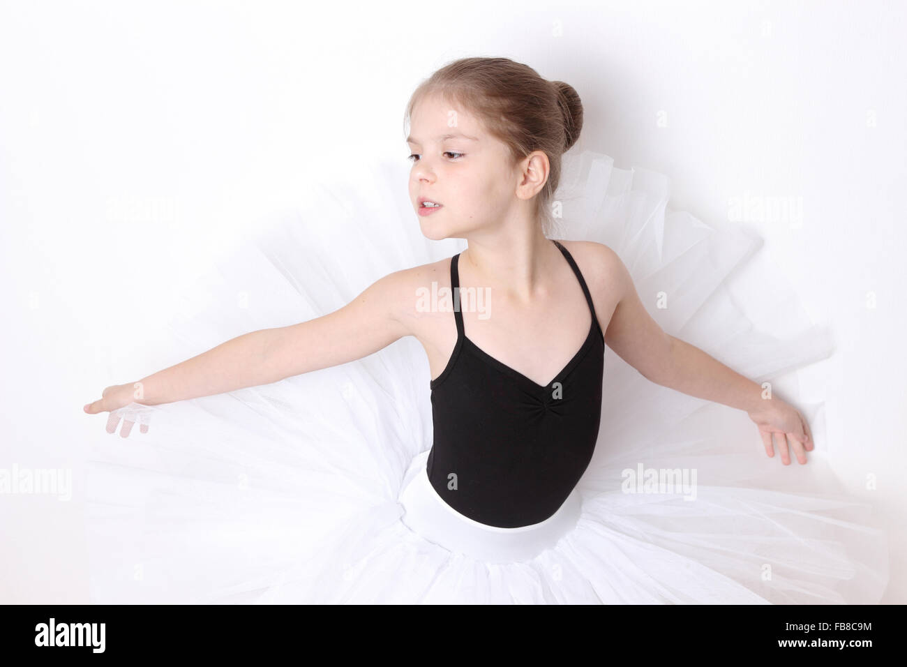 little ballerina in studio posing on camera Stock Photo