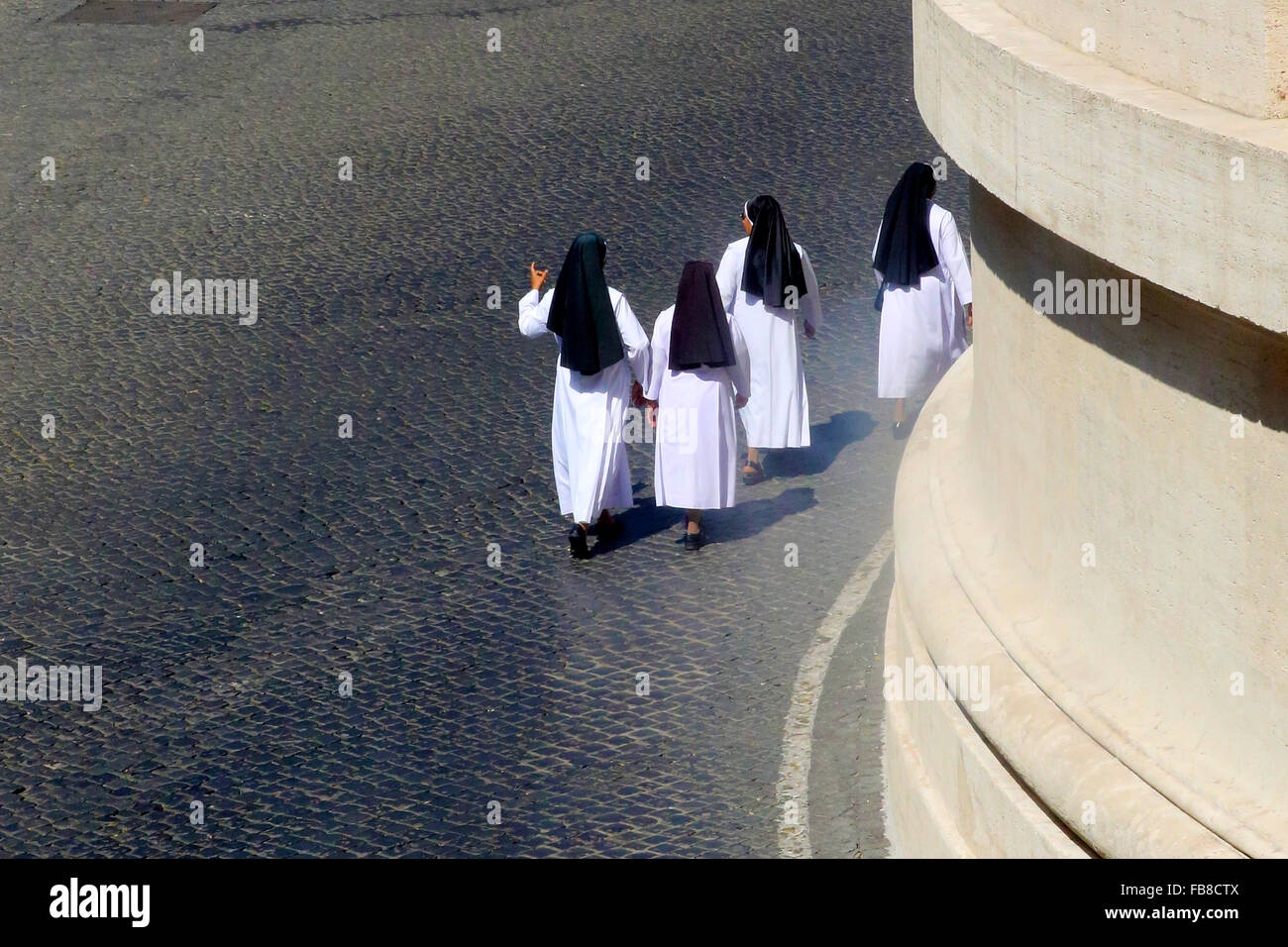Four nuns walking in Vatican City Stock Photo