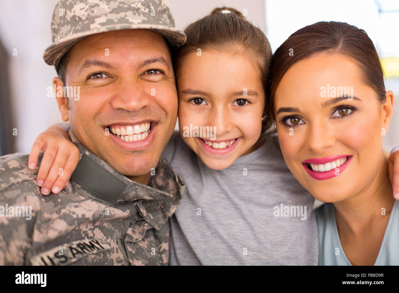 happy military family of three relaxing together at home Stock Photo