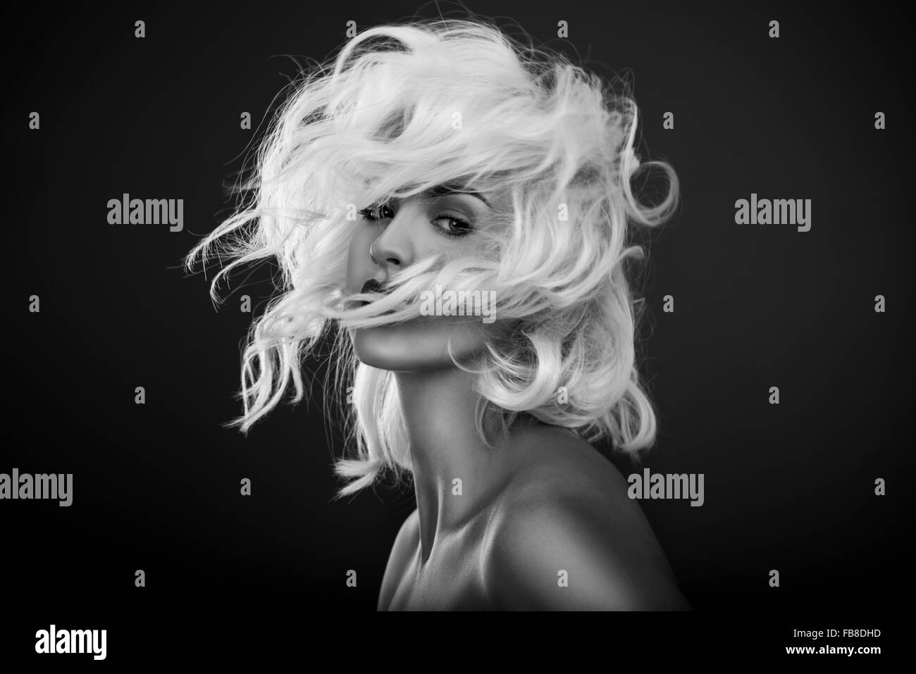 Black and white fashion portrait, model with white hair blowing. Hair salon Stock Photo