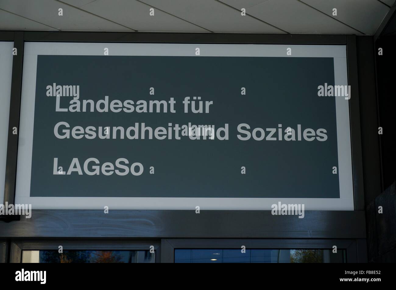 A sign with the inscription 'Landesamt fuer Gesundheit und Soziales LAGeSo' (lit. Regional Office for Health and Social Affairs) at the registration office for refugees in the Bundesallee in Berlin Wilmersdorf, Germany, 26 October 2015. Since October/November 2015, the Federal Office for Migration and Refugees (BAMF), which is part of the Regional Office for Health and Social Affairs (LAGeSo), the Foreigners' Authority, and the Federal Labour Office have been located in the building of the former Landesbank Berlin (LBB) in order to accelerate the registration of refugees and to relieve the Reg Stock Photo