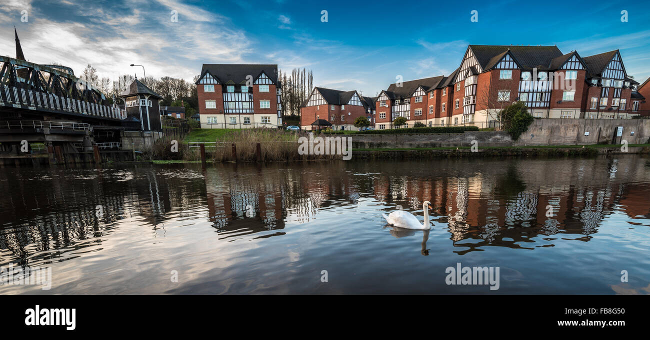 Newly developed mock Tudor housing along the river Weaver with the Hayhurst electrical swing bridge in Northwich, Cheshire, Uk. Stock Photo