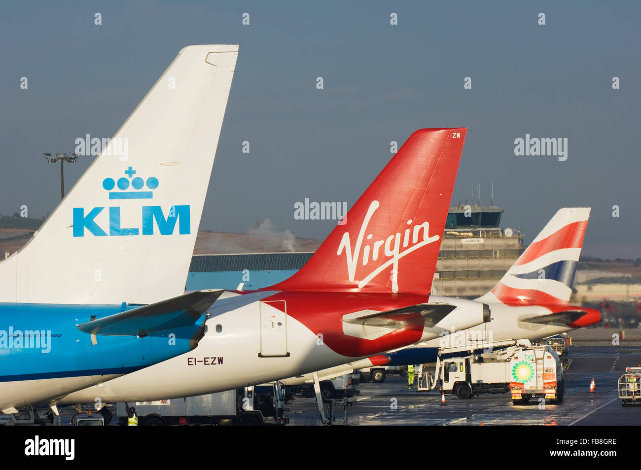 Aircraft tails showing the markings of different airlines - Aberdeen airport, Scotland. Stock Photo