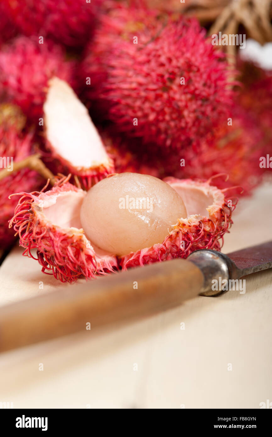 fresh tropical rambutan fruits over rustic wood table Stock Photo - Alamy