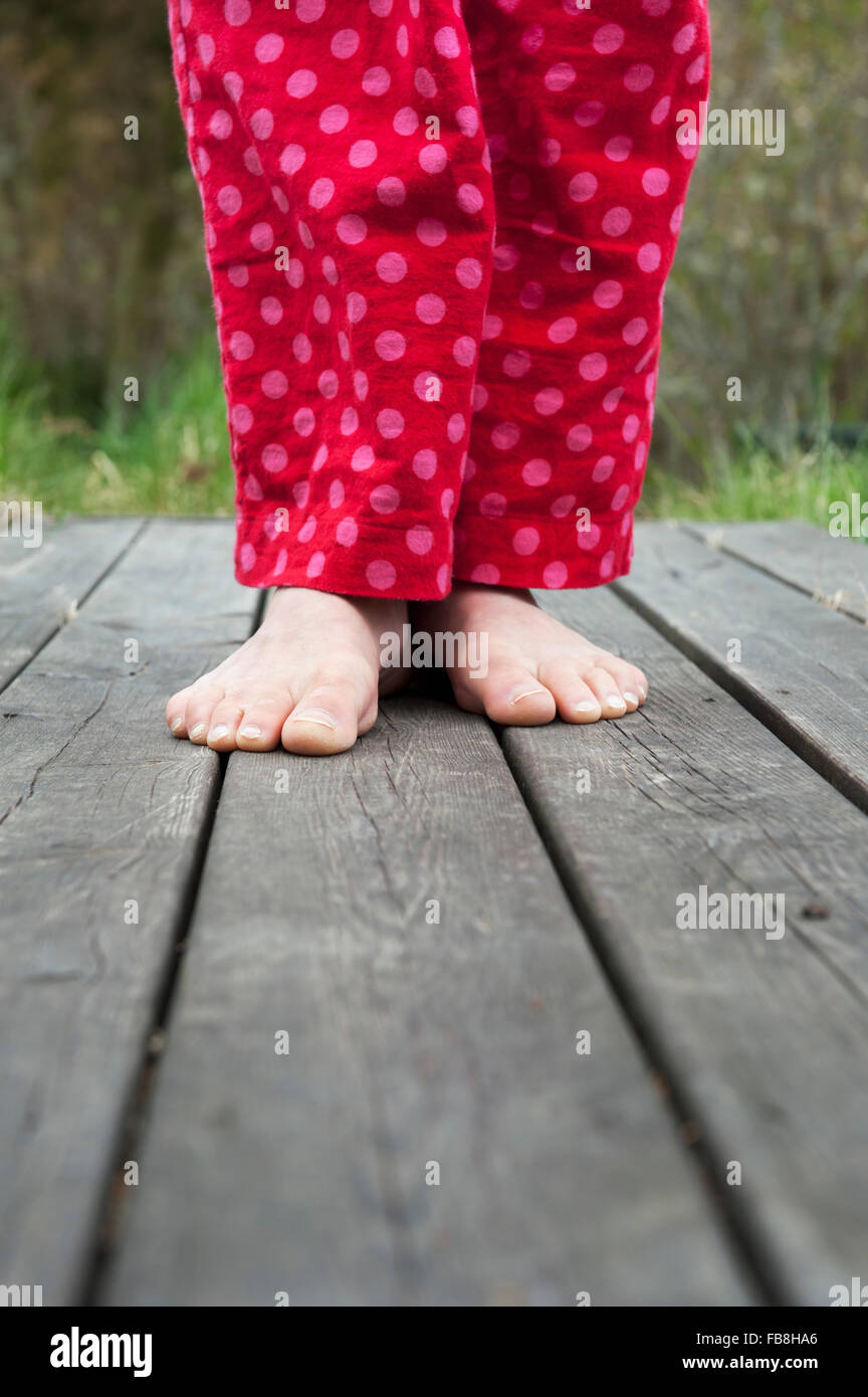 Sweden, Ostergotland, Vikbolandet, Low-section of woman in pajamas Stock Photo