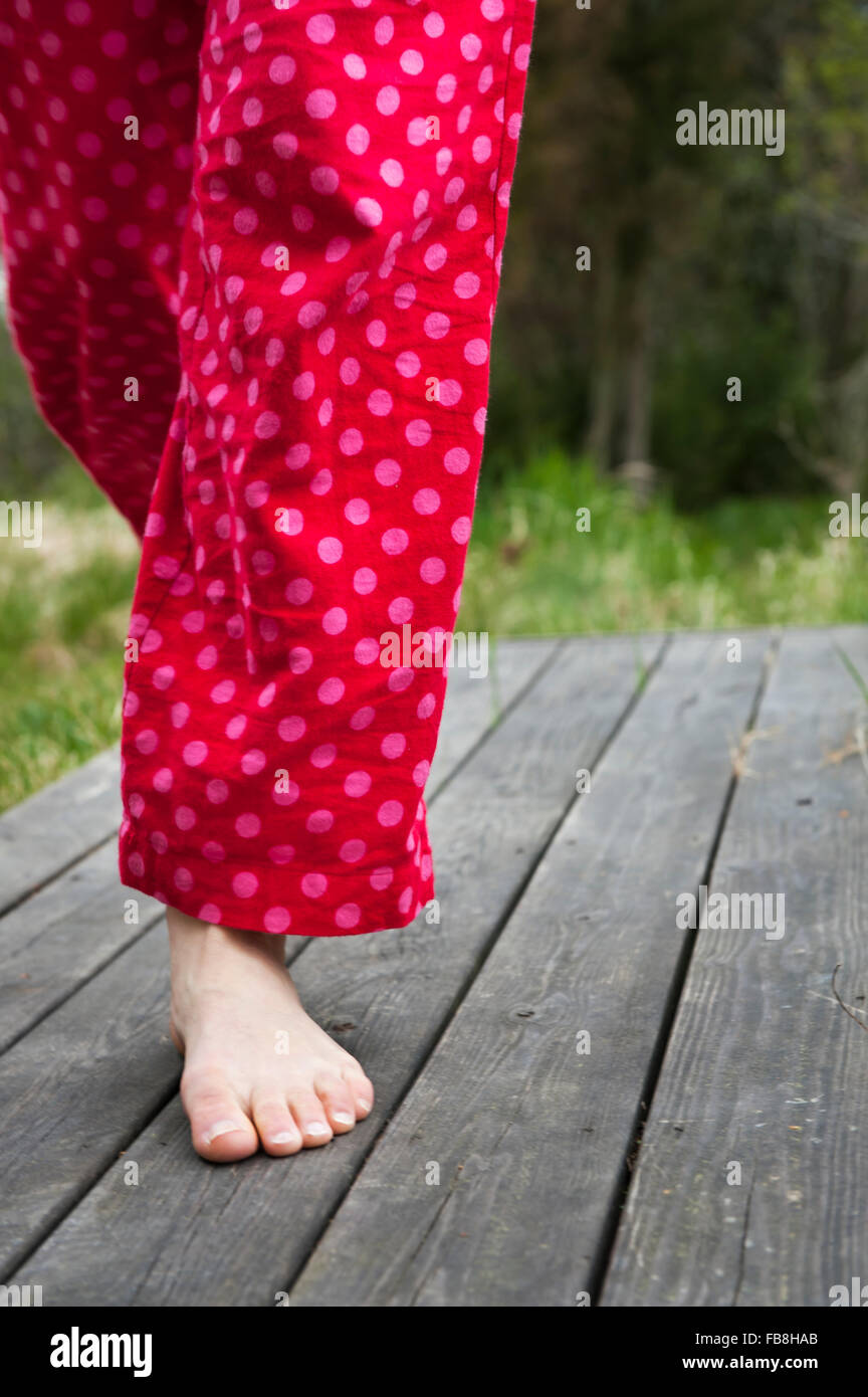 Sweden, Ostergotland, Vikbolandet, Low-section of woman in pajamas Stock Photo