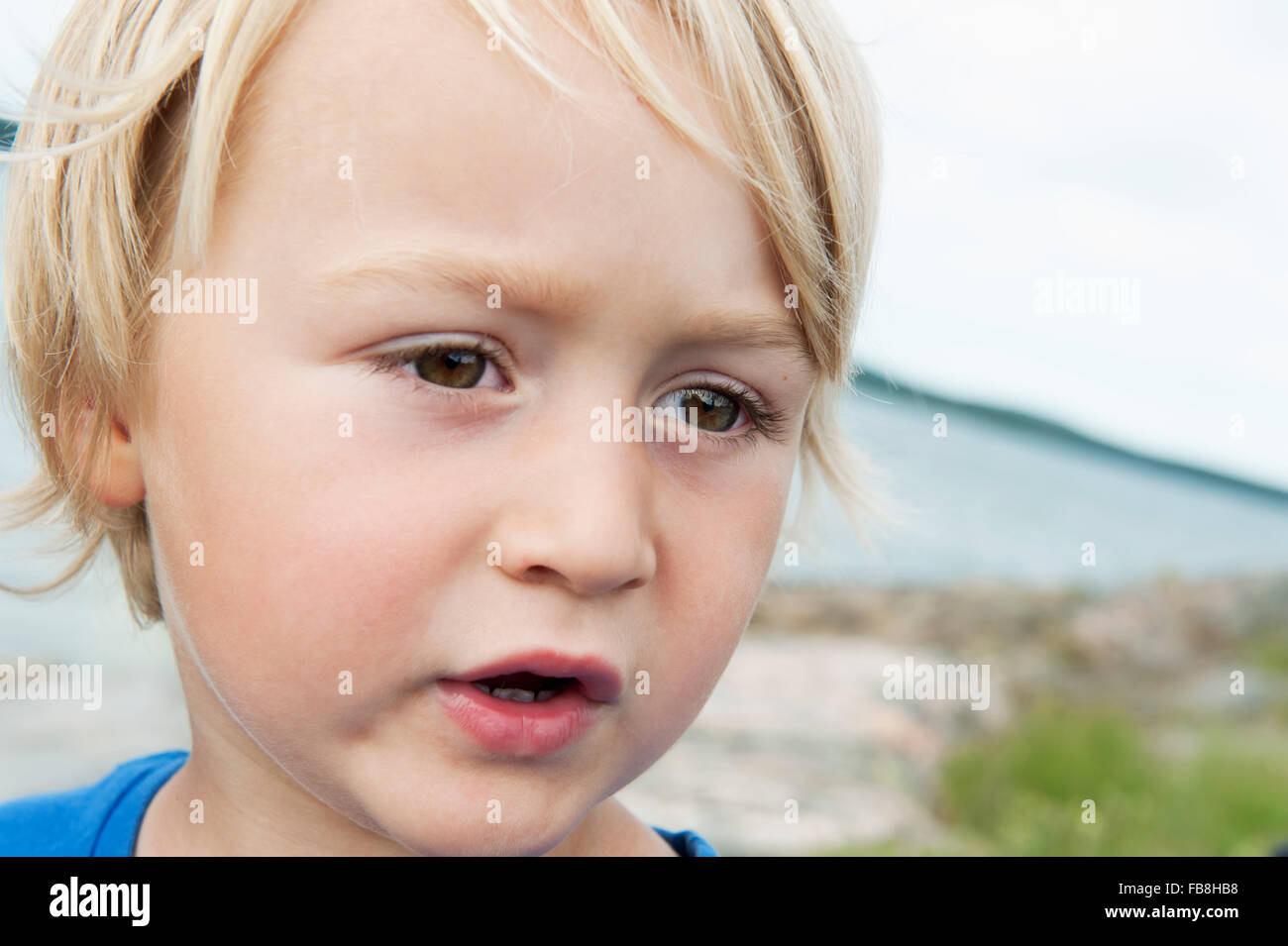 Sweden, Ostergotland, Vikbolandet, Boy (2-3) with brown eyes on beach Stock Photo
