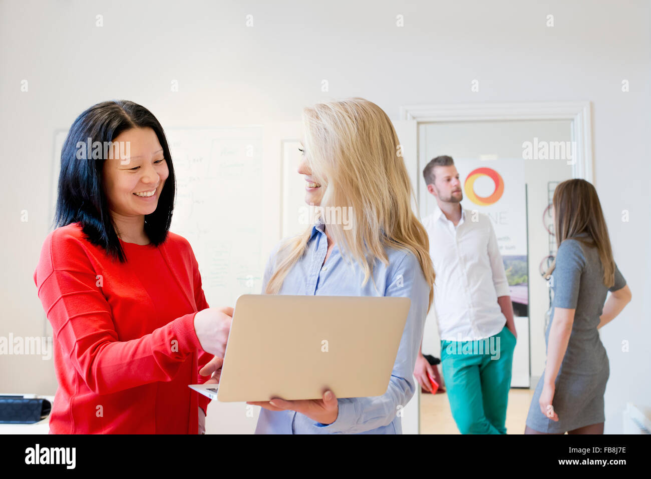 Sweden, Woman helping colleague Stock Photo