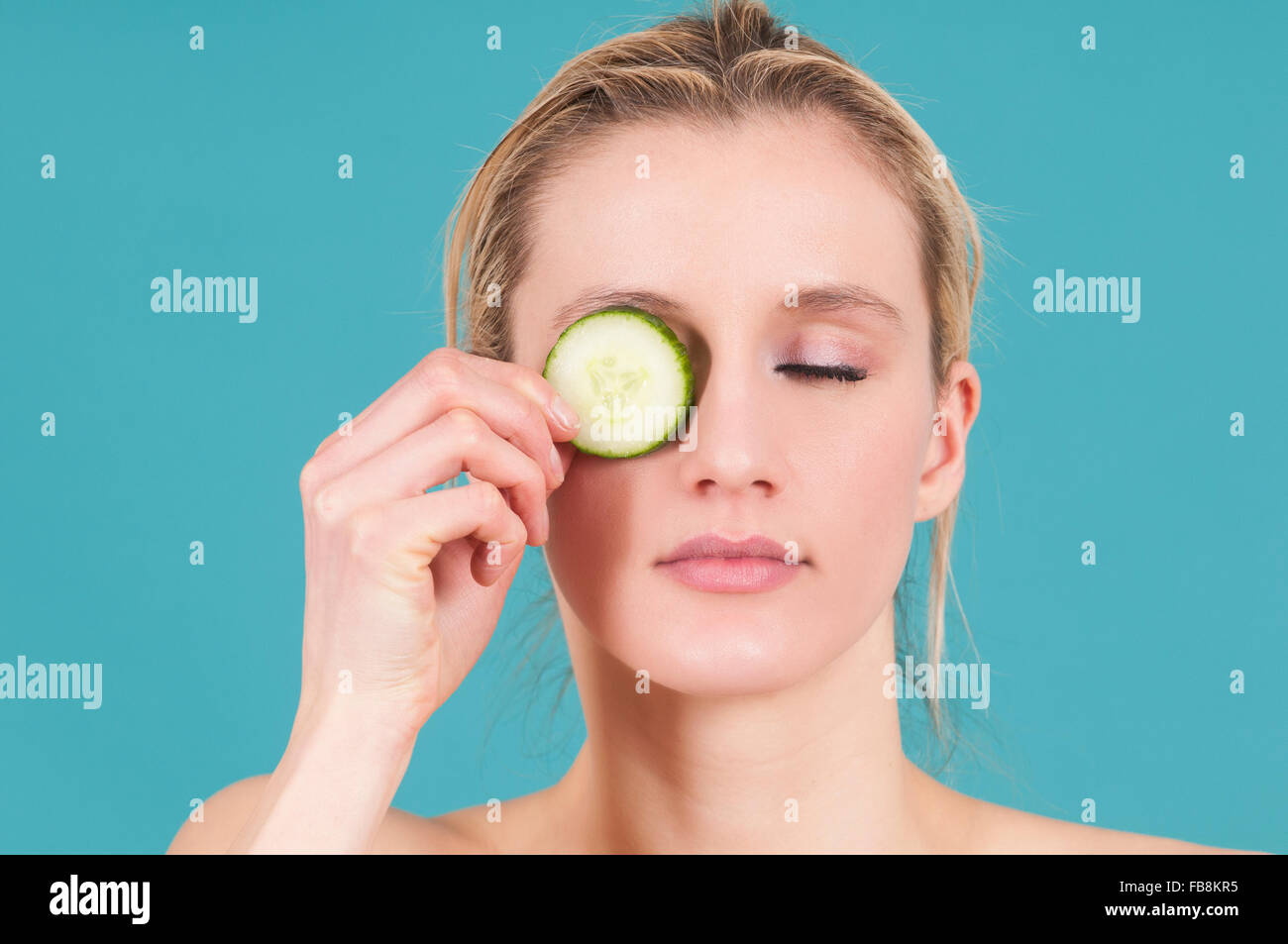 Woman with slices of cucumbers covering her eyes Stock Photo Alamy
