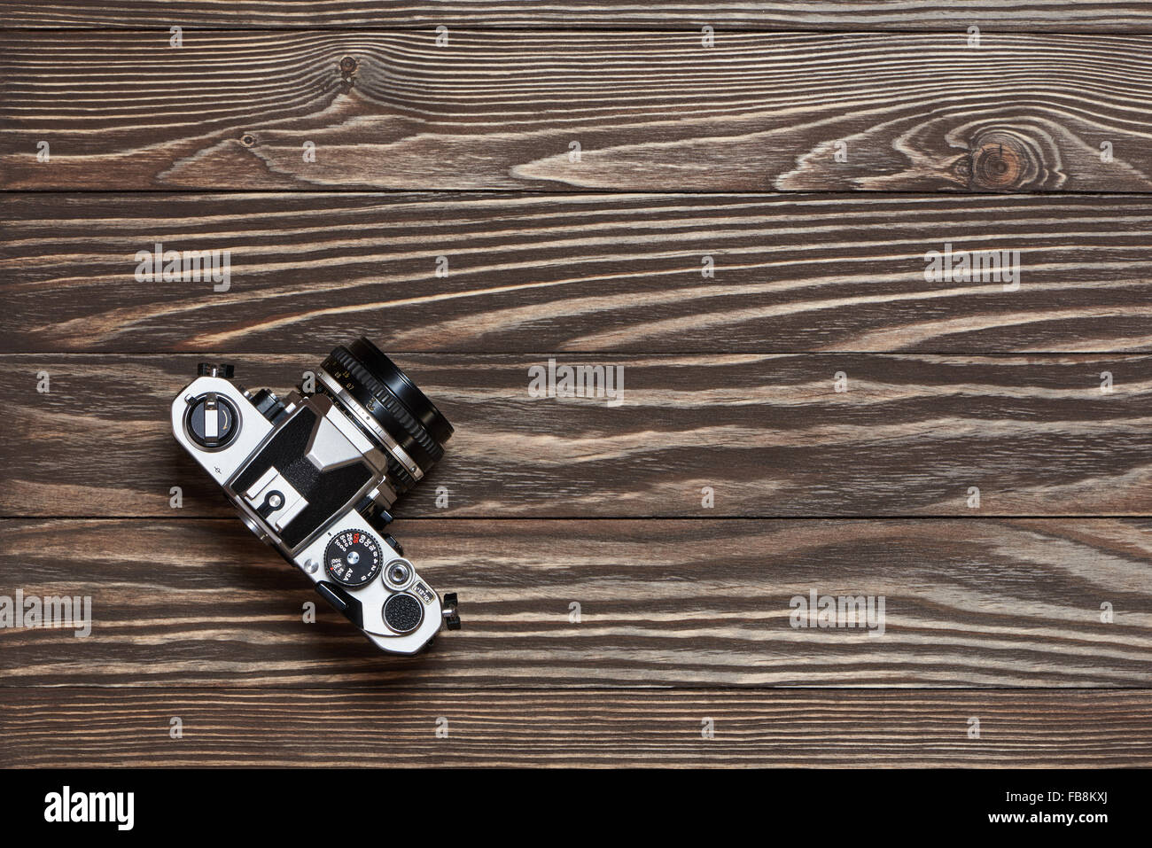 Retro SLR camera on old wooden background top view Stock Photo