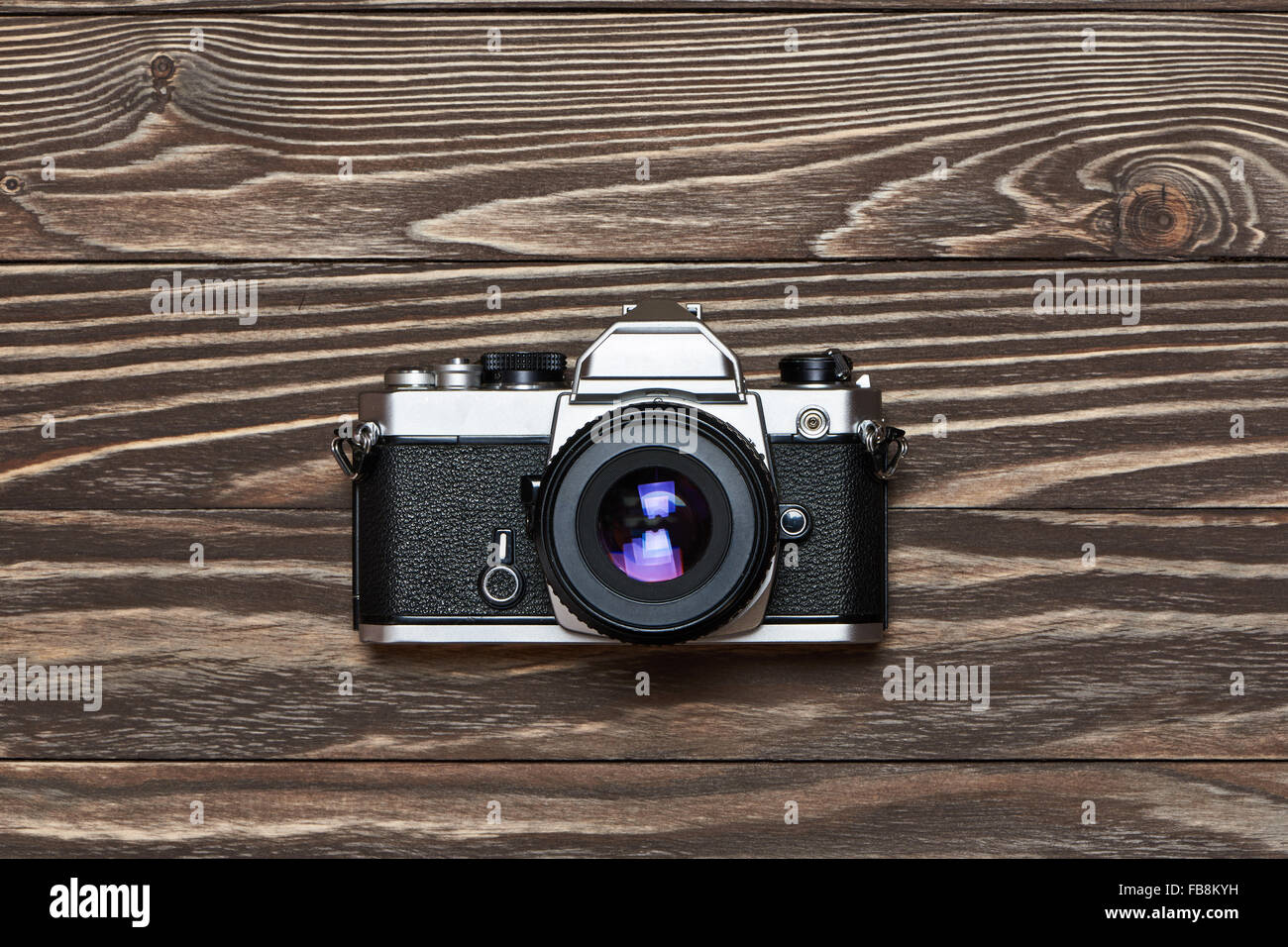 Retro SLR camera on old wooden background center Stock Photo
