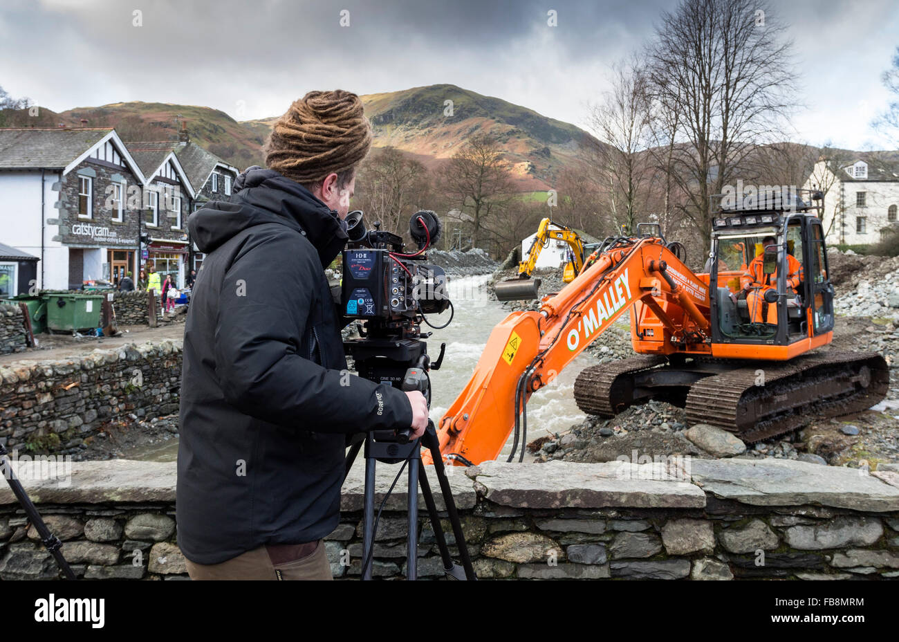 TV Cameraman Filming the Aftermath of the Glenridding Floods Caused by Storm Desmond in December 2015 Lake District Cumbria Stock Photo