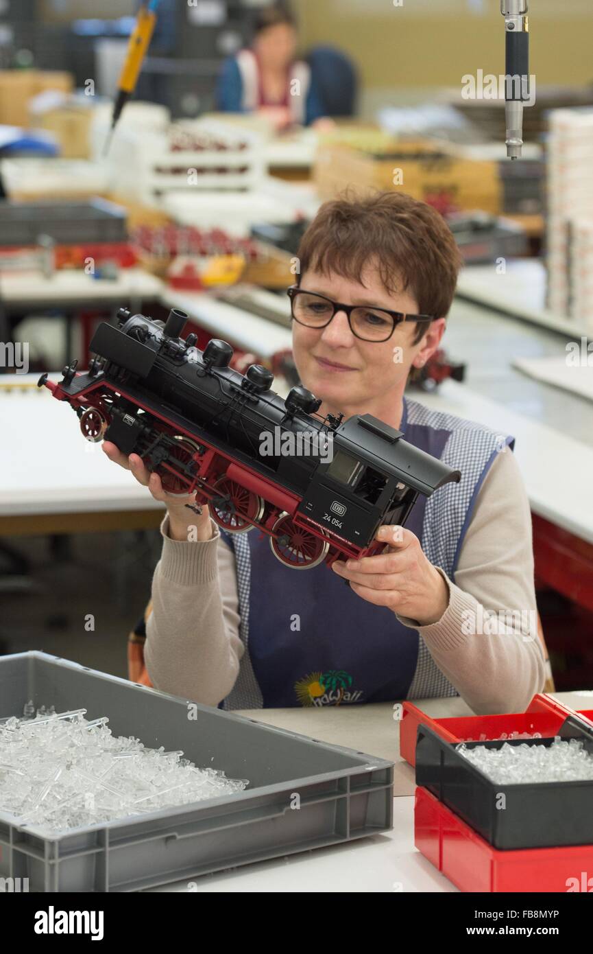 Sonneberg, GErmany. 12th Jan, 2016. Technician Cornelia Morawe inspects the running gear of a tender locomotive in the production facility of model train manufacturer Piko Spielwaren GmbH at a press conference in Sonneberg, GErmany, 12 January 2016. The company's general manager Rene Wilfer gave a briefing on the sales development of the past year. Photo: SEBASTIAN KAHNERT/dpa/Alamy Live News Stock Photo